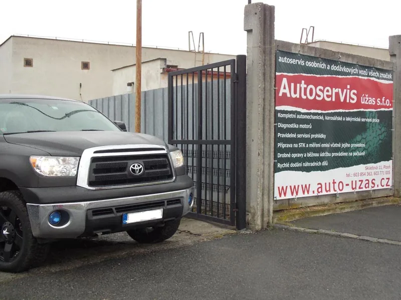 Pick-up zaparkovaný u vjezdu do areálu autoservisu
